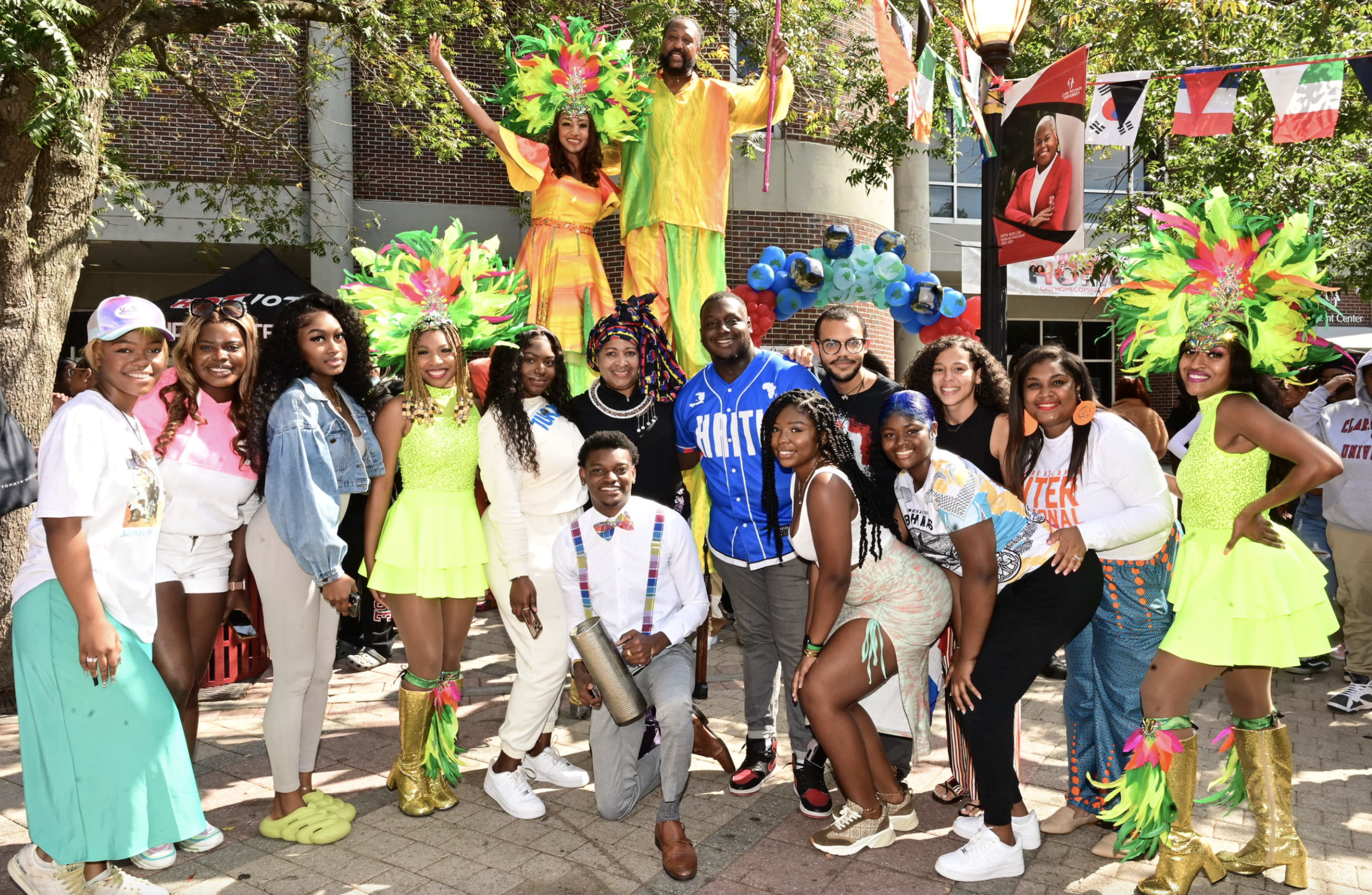 Group of people celebrating outdoors, colorful attire, festive mood.