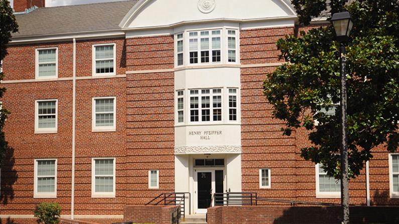 Red brick building with white trim and symmetrical windows.