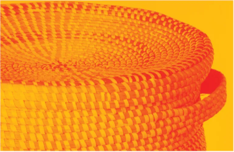 Woven basket with textured pattern on a bright yellow background.
