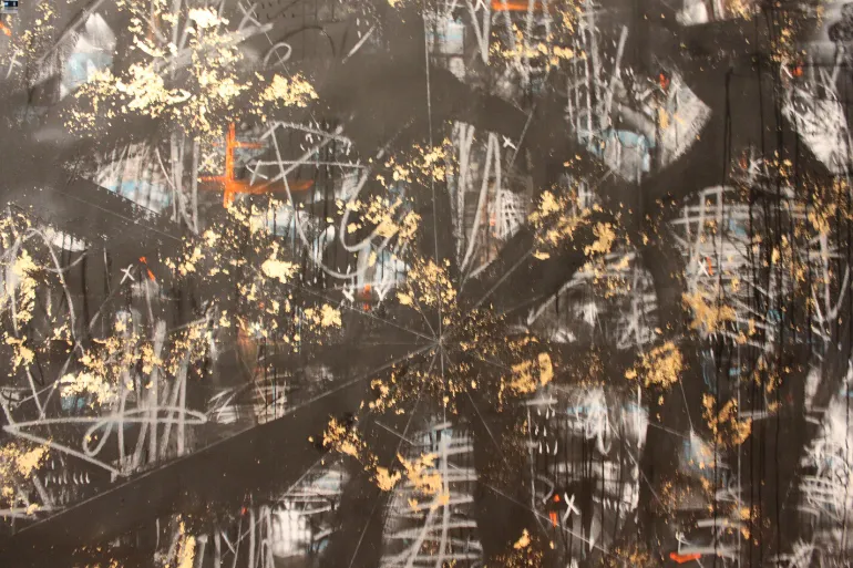 Abstract painting with gold, black, and white brushstrokes.