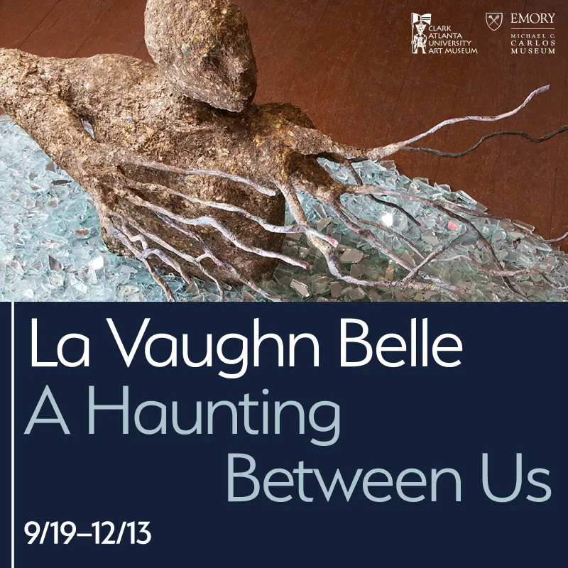 Sculpture of figure emerging from broken glass.