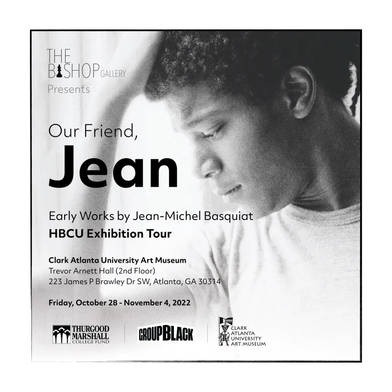 Black and white portrait of a young man with curly hair, gazing downwards.