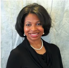 Rae M. Warner, M.A. Associate Director for New Student and Family Programs with shoulder-length hair wearing a black top and pearl necklace.