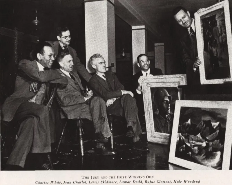 Black and white photo of six men examining framed art.