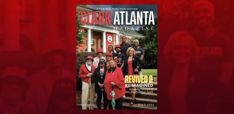 Diverse group stands on university steps, smiling, in red and black attire.