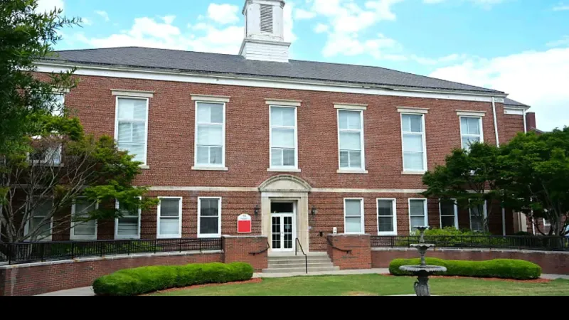 Red-brick building with white-trimmed windows and a cupola.
