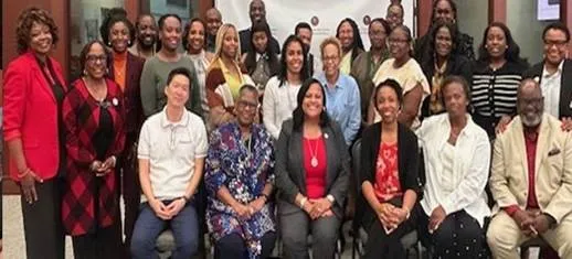 Group of smiling people posing together indoors.