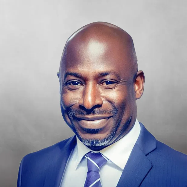 Smiling man in a suit against a gray background.