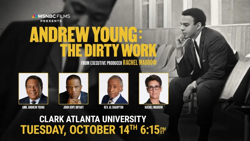 Black and white photo of a man in a suit, seated thoughtfully.