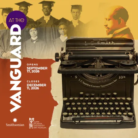 A vintage typewriter with a sepia-toned backdrop of graduates and a seated man.